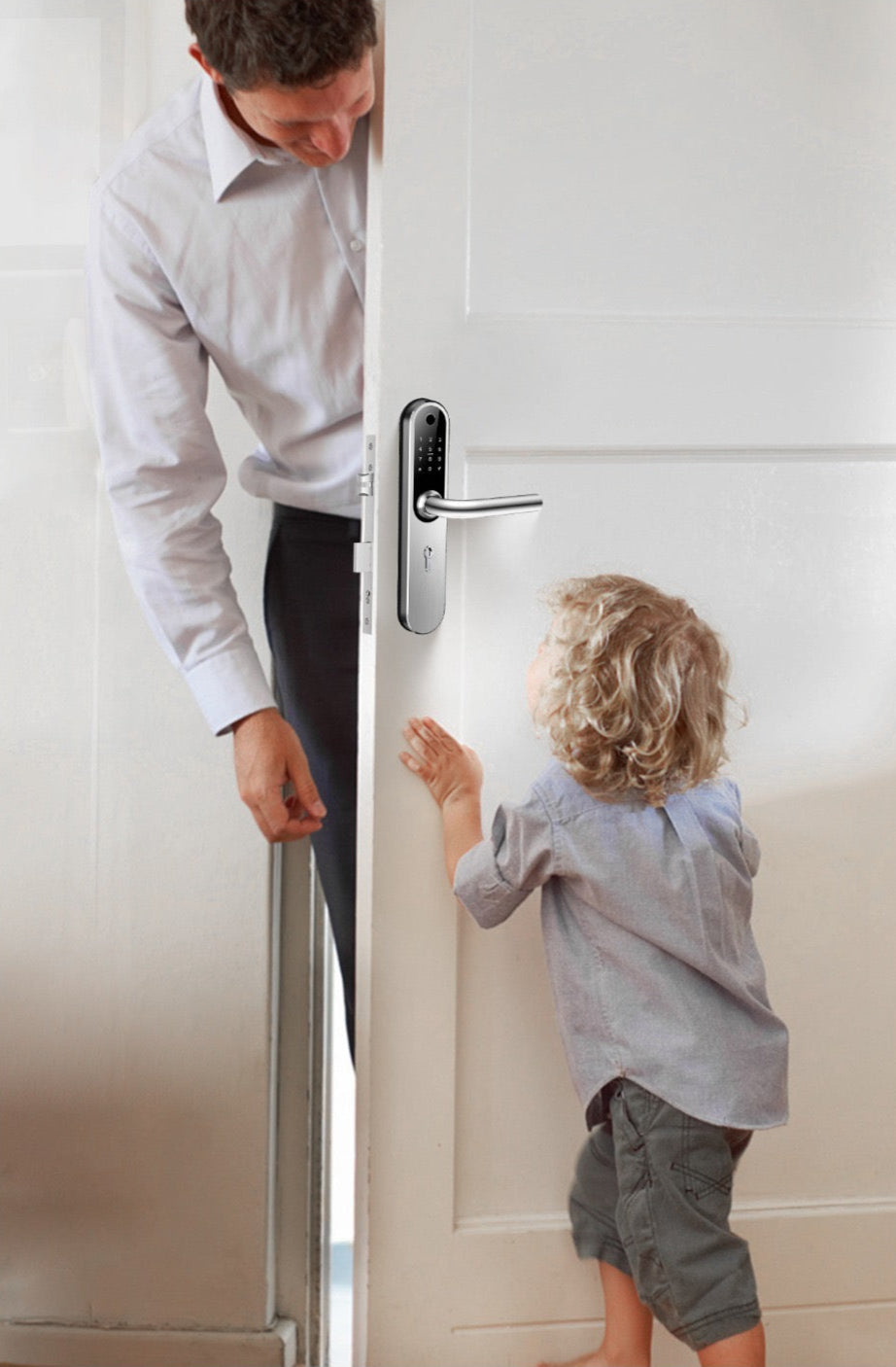 Man and child standing in a doorway with a modern door handle.